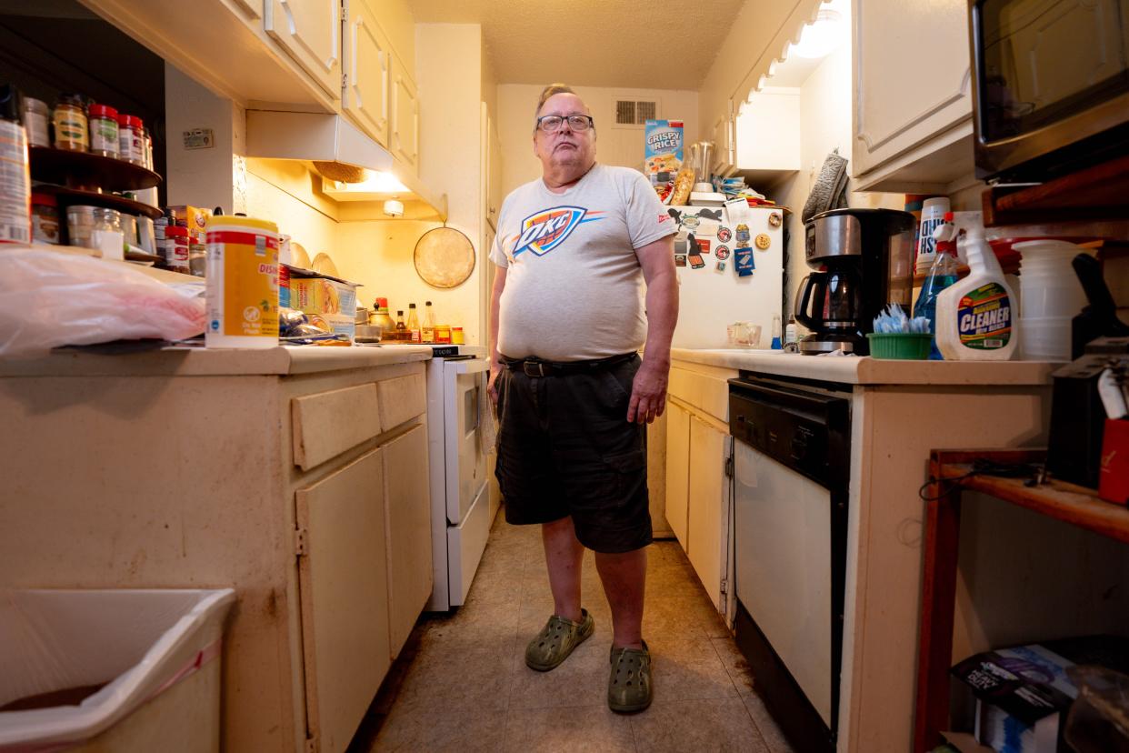 John Doyle stands in the kitchen of his apartment in Oklahoma City.