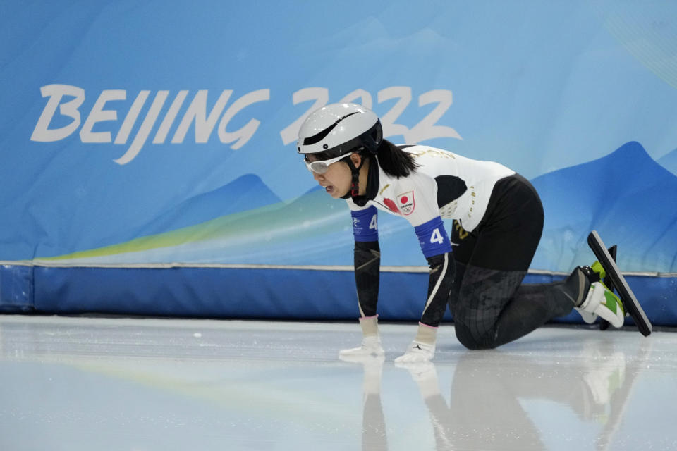 Nana Takagi of Team Japan reacts after falling during the speedskating women's team pursuit finals at the 2022 Winter Olympics, Tuesday, Feb. 15, 2022, in Beijing. (AP Photo/Ashley Landis)