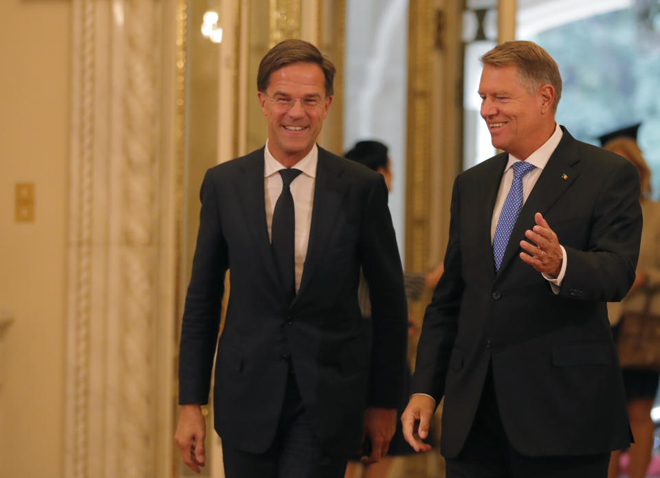 Dutch Prime Minister Mark Rutte, left, is welcomed by Romanian President Klaus Iohannis at the Cotroceni Presidential Palace in Bucharest, Romania, Wednesday, Sept. 12, 2018. Rutte is on a one day official visit to Romania.(AP Photo/Vadim Ghirda)