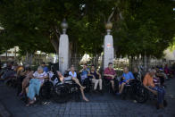 Seniors who live at a nursing home sit outside their home after they were evacuated due to an earthquake in Ponce, Puerto Rico, Tuesday, Jan. 7, 2020. A 6.4-magnitude earthquake struck Puerto Rico before dawn on Tuesday, killing one man, injuring others and collapsing buildings in the southern part of the island. (AP Photo/Carlos Giusti)