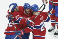 Montreal Canadiens' Corey Perry, centre, celebrates his goal with teammates Jeff Petry, left, and Eric Staal during the first period of an NHL Stanley Cup playoff hockey game in Montreal, Sunday, June 6, 2021. (Paul Chiasson/The Canadian Press via AP)