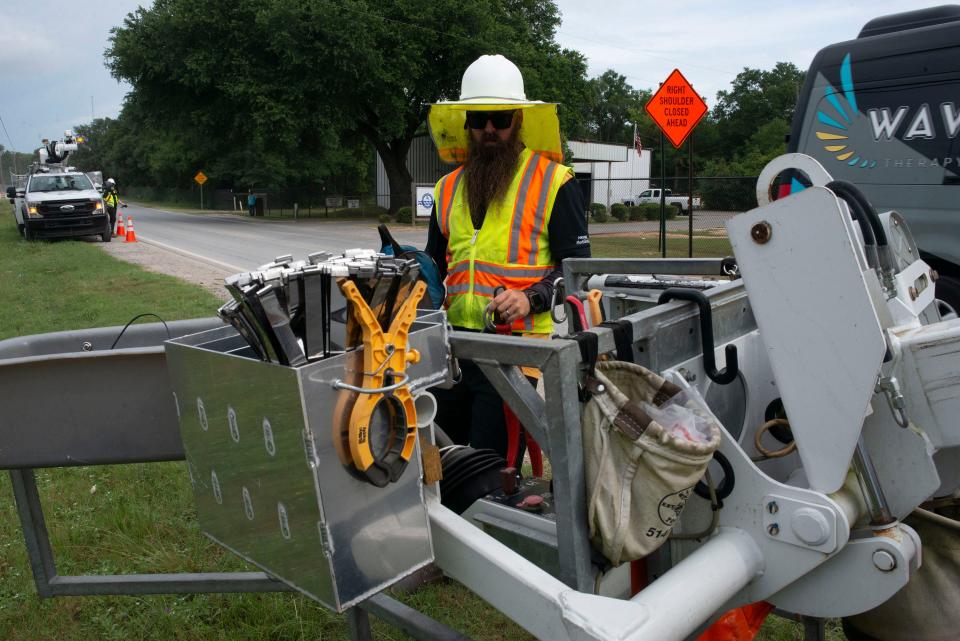 Mediacom technician Theo Dinwiddie prepares to begin work upgrading the internet and cable provider's infrastructure in the East Milton area on Wednesday.