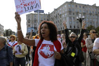 A woman wearing a T-shirt with a sign of an old Belarusian flag during an opposition rally to protest the official presidential election results in Minsk, Belarus, Saturday, Sept. 12, 2020. Daily protests calling for the authoritarian president's resignation are now in their second month and opposition determination appears strong despite the detention of protest leaders. (AP Photo)