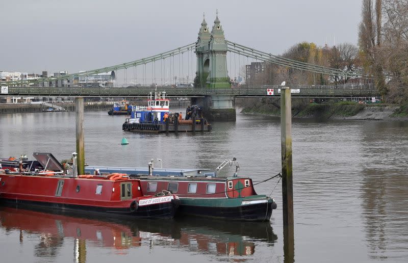 Houseboats are seen moored near Hammersmith Bridge, the closure of which has caused the annual Oxford versus Cambridge boat race on the River Thames to be relocated, London, Britain