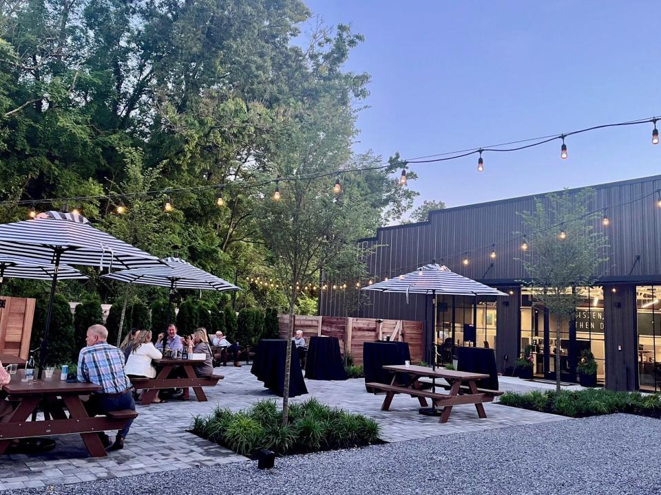 Behind Johnson Architecture's new South Knoxville headquarters, a private enclosed courtyard with tables and nearby trees can serve as an area for hosting company or client events or as a break area. The rear also looks out on the site of the proposed 1.5-mile-long SoKno Art Trail. May 2024