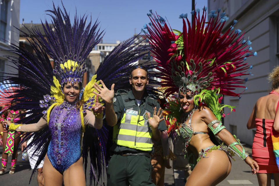 A paramedic joins dancers during the the Notting Hill Carnival in west London, Monday, Aug. 26, 2019. (Photo: Aaron Chown/PA via AP)