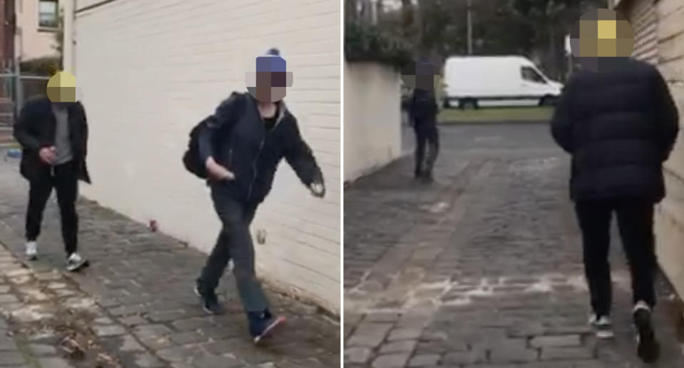 Two men walk down a Richmond laneway.