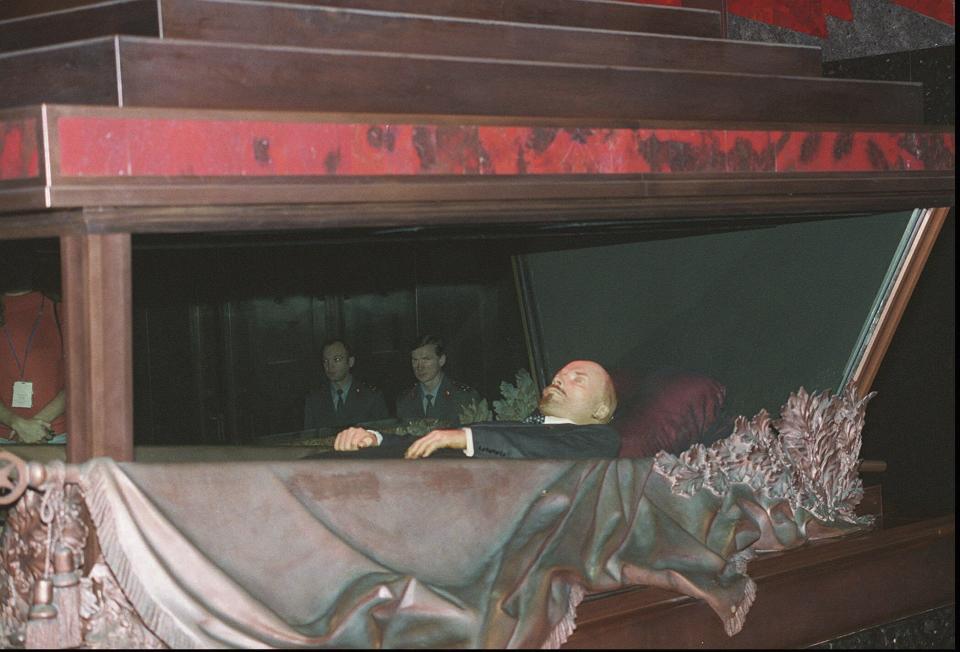 FILE – The embalmed corpse of Vladimir Lenin, the founder of the Soviet Union, lies behind glass in his mausoleum on Red Square outside the Kremlin wall in Moscow, Russia, in this photo taken on Nov. 30, 1994. On the 100th anniversary of his death, Lenin is still lauded by Communists, but he is more of an afterthought in modern Russia. (AP Photo, File)