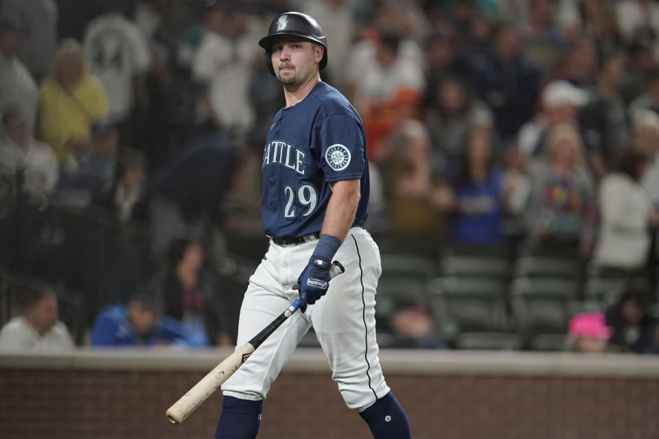 Seattle Mariners' Cal Raleigh walks off the field after he struck out swinging with the bases loaded to end the eighth inning of the team's baseball game against the Houston Astros, Friday, July 22, 2022, in Seattle. (AP Photo/Ted S. Warren)