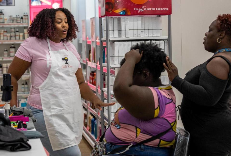 A estilista da marca Camille Rose, Eve, à esquerda, conversa com as clientes sentadas Ashleigh e Shawna Powell, à direita, durante uma sessão de consulta dentro da loja Ulta Beauty em Miami.  Uma equipe da Camille Rose Beauty Products apresenta e instrui os clientes sobre sua linha de produtos de beleza na loja Ulta Beauty em 10001 Flagler St., Miami na quarta-feira, 29 de novembro de 2023.