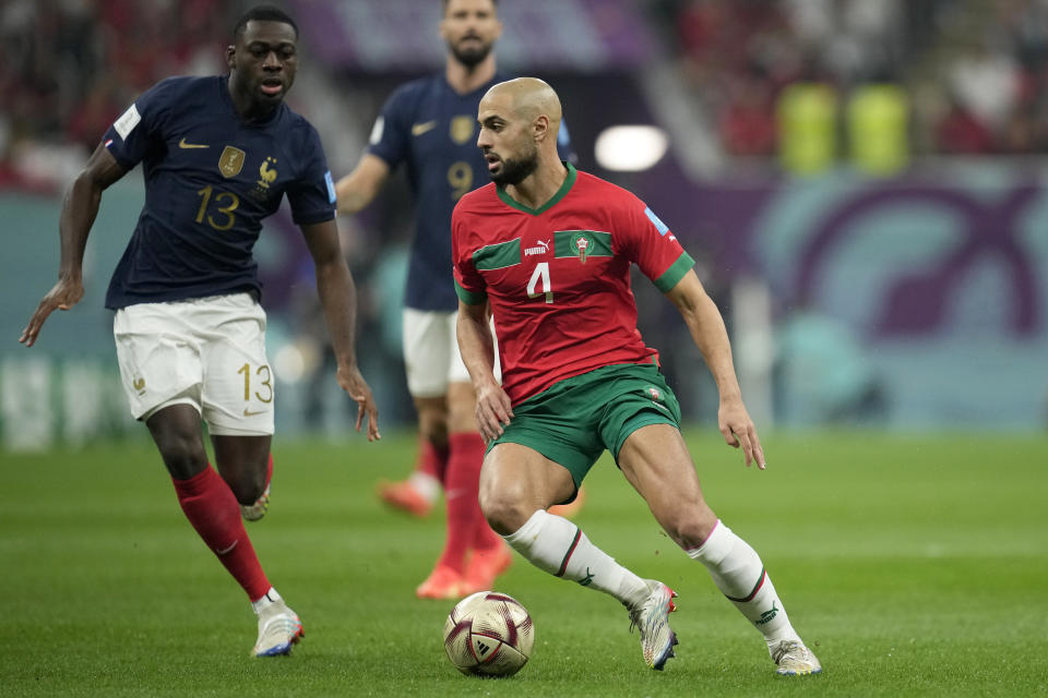 Morocco's Sofyan Amrabat runs with the ball during the World Cup semifinal soccer match between France and Morocco at the Al Bayt Stadium in Al Khor, Qatar, Wednesday, Dec. 14, 2022. (AP Photo/Christophe Ena)