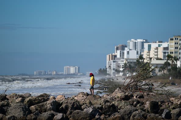 A man looks out to the Gulf of Mexico after Hurricane Ian on September 29, 2022, in Naples, Florida.