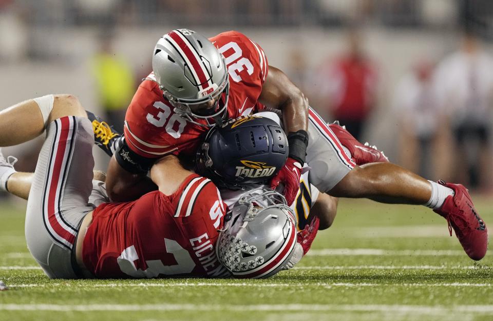 Sep 17, 2022; Columbus, Ohio, USA; Toledo Rockets wide receiver DeMeer Blankumsee (0) is tackled by Ohio State Buckeyes linebacker Tommy Eichenberg (35) and Ohio State Buckeyes linebacker Cody Simon (30) during Saturday's NCAA Division I football game at Ohio Stadium. Mandatory Credit: Barbara Perenic/Columbus Dispatch
