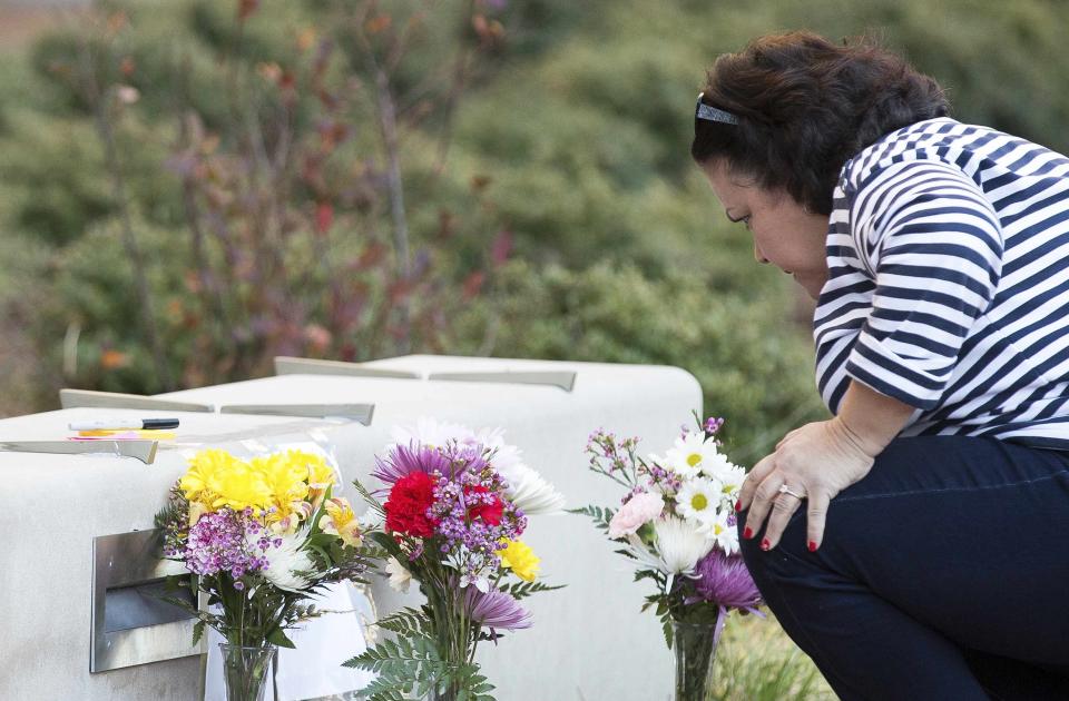 A woman stops to read a note at a makeshift memorial outside the University of North Carolina School of Dentistry, for Deah Shaddy Barakat, his wife Yusor Mohammad and Yusor's sister Razan Mohammad Abu-Salha who were killed in Chapel Hill, North Carolina February 11, 2015. Gunman Craig Stephen Hicks, who had posted anti-religious messages on Facebook and quarreled with neighbors, was charged with killing the three young Muslims in what police said on Wednesday was a dispute over parking and possibly a hate crime. Barakat was a dental student at the University of North Carolina. (REUTERS/Chris Keane)