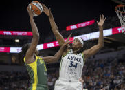 Minnesota Lynx center Sylvia Fowles (34) blocks a shot from Seattle Storm's Tina Charles during the second quarter of a WNBA basketball game Friday, Aug. 12, 2022, in Minneapolis. (Elizabeth Flores/Star Tribune via AP)