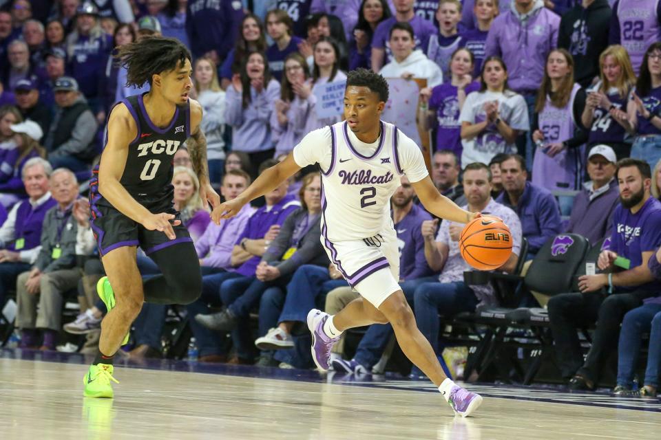 Kansas State guard Tylor Perry (2) dribbles away from TCU's Micah Peavy (0) on Saturday at Bramlage Coliseum.