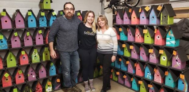 Members of the Champ family are pictured here with their birdhouses. Jamie, far left, Maddie, middle, and Carol, far right.