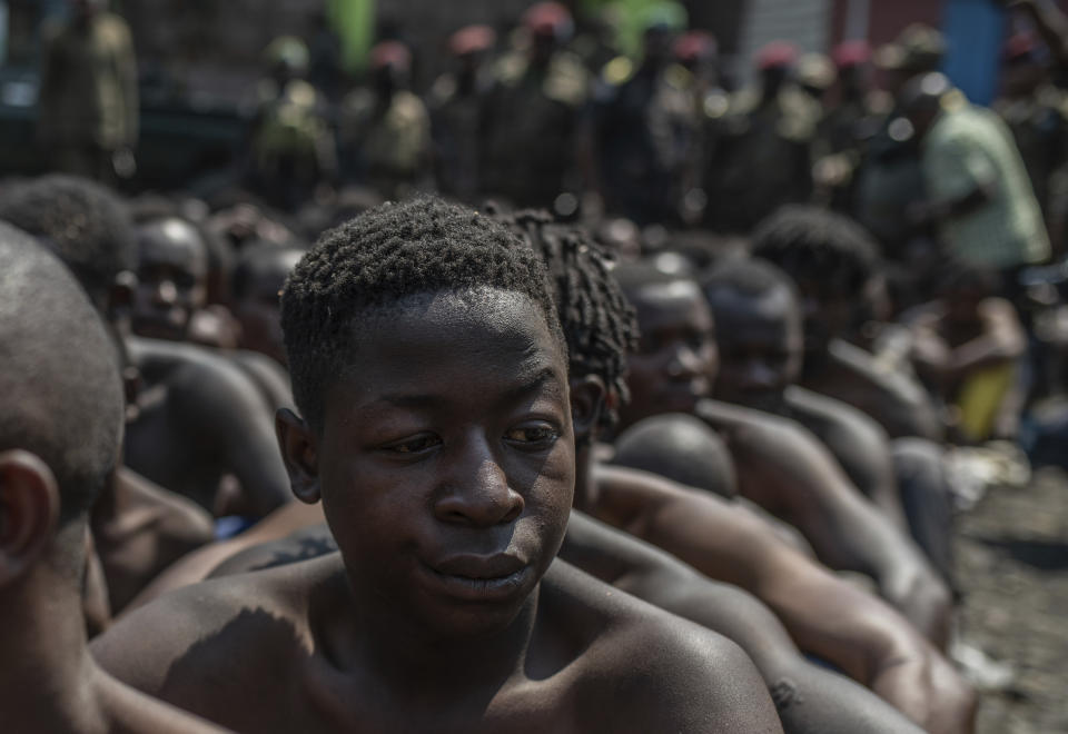 Arrested members of the Wazalendo sect are sat and lined up in Goma, Democratic Republic of the Congo, Wednesday, Aug. 30, 2023. More than 40 people died and dozens were injured in clashes in the Congolese city of Goma between protesters from the Wazalendo religious sect and the armed forces, national authorities said. (AP Photo/Moses Sawasawa)