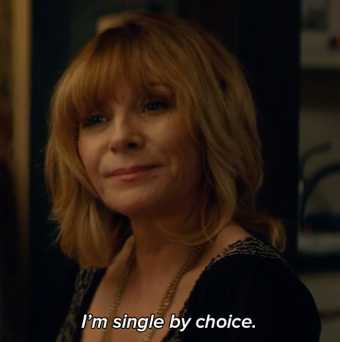 A woman smiling with the words, "I'm single by choice"