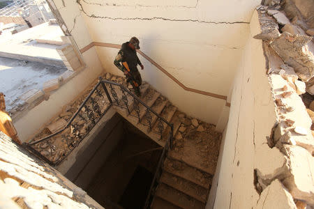 An Iraqi Christian soldier walks in the damaged Church of the Immaculate Conception after Iraqi forces recaptured it from Islamic State in Qaraqosh, near Mosul, Iraq, December 9, 2016. REUTERS/Alaa Al-Marjani