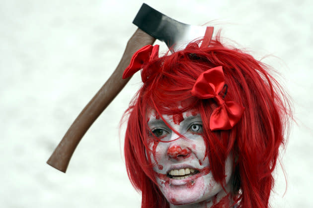 A woman dressed as a zombie participates in the first edition of a "Zombie Walk" event on November 3, 2012, in Yverdon-les-Bains, Switzerland. Wearing gruesome costumes and make-up, participants groaned through the city's downtown area. AFP PHOTO / FABRICE COFFRINI