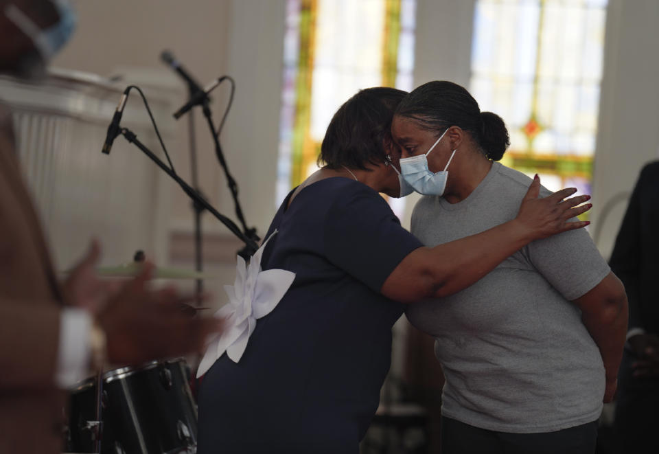 The Rev. Cynthia Walters, left, hugs Dalceada Williams, who stands at the front of the church for a special prayer on Sunday, April 16, 2023, at Zion Baptist Church in Columbia, S.C. Despite a drop in in-person church attendance, Zion's Rev. M. Andrew Davis says that the Black churches remain fundamental to the community by continuing to provide refuge and hope, especially during times of challenge. (AP Photo/Jessie Wardarski)