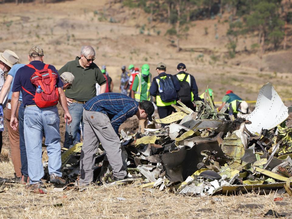 A group of investigators look over the debris left by a 2019 Boeing 737 MAX crash.