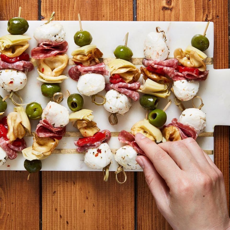 <p>Fresh tortellini makes this the hearty appetiser of our dreams. If you're not a fan of olives, pepperoncini peppers would be a delicious substitute! </p><p>Get the <a href="https://www.delish.com/uk/cooking/recipes/a35262428/antipasto-bites-recipe/" rel="nofollow noopener" target="_blank" data-ylk="slk:Antipasto Bites;elm:context_link;itc:0;sec:content-canvas" class="link ">Antipasto Bites</a> recipe.</p>