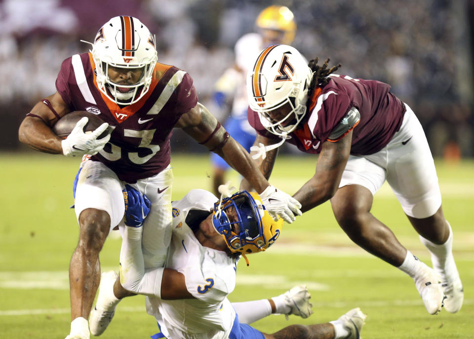 Virginia Tech running back Bhayshul Tuten (33) gets away from a tackle attempt by Pittsburgh's Daejon Reynolds (3) during the second quarter of an NCAA college football game Saturday, Sept. 30, 2023, in Blacksburg, Va. (Matt Gentry/The Roanoke Times via AP)