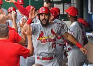 Aug 10, 2018; Kansas City, MO, USA; St. Louis Cardinals first baseman Matt Carpenter (13) celebrates in the dugout after hitting a two run home run during the second inning against the Kansas City Royals at Kauffman Stadium. Mandatory Credit: Peter G. Aiken/USA TODAY Sports