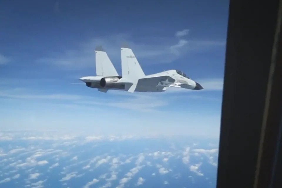 Footage captured on Dec. 21, 2022 shows a Chinese fighter jet flying close to a U.S. surveillance plane in international airspace over the South China Sea.  (U.S. Indo-Pacific Command)