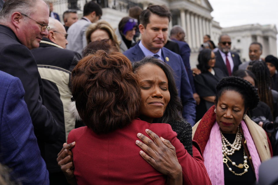 Serena Liebengood, center right, widow of U.S. Capitol Police officer Howard Liebengood, embraces Rep. Maxine Waters, D-Calif., on the second year anniversary of the violent insurrection by supporters of then-President Donald Trump, in Washington, Friday, Jan. 6, 2023. (AP Photo/Matt Rourke)