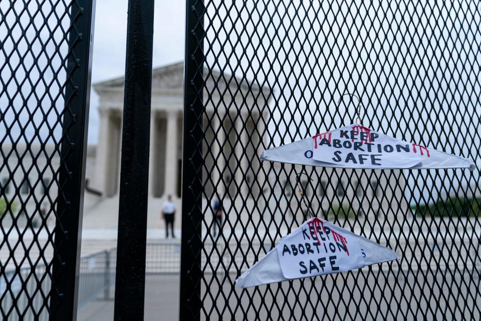 Coat hangers recalling the pre-Roe v. Wade era on the anti-scaling fence outside of the U.S. Supreme Court on May 5, 2022, in Washington, D.C.