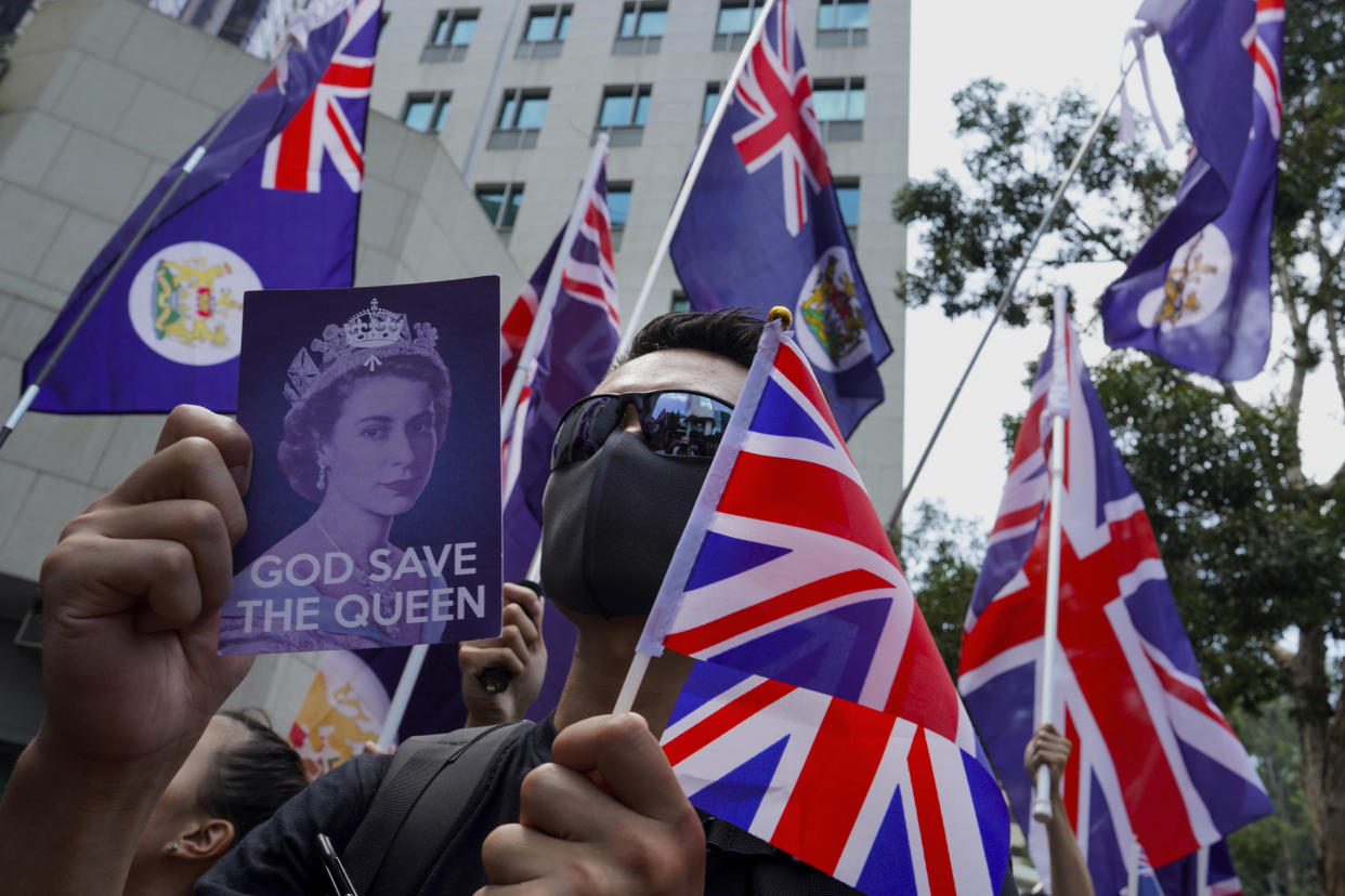 Protesters hold placards and British flags during a peaceful demonstration outside the British Consulate in Hong Kong, Sunday, Sept. 15, 2019. Hundreds of Hong Kong activists rallied outside the Consulate for a second time this month, bolstering calls for international support in their months-long protests for democratic reforms in the semi-autonomous Chinese territory. (AP Photo/Vincent Yu)