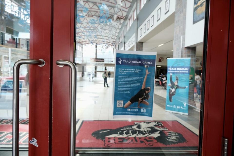 Fliers advertising the Traditional Games in Juneau are posted on the door at Juneau Douglas High School: Yadaa.at Kalé on April 7, 2024. (Photo by Claire Stremple/Alaska Beacon)