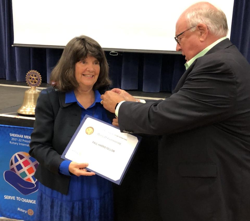 Mary Gannaway accepts a Paul Harris Fellowship from Elias Thomas, of the Sanford-Springvale Rotary Club, following a presentation she delivered to the organization at the Nasson Little Theater on Thursday, June 9, 2022.