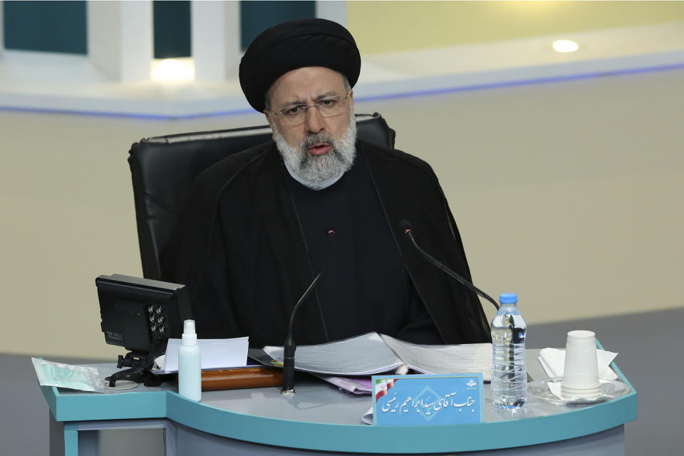 In this photo made available by the government-affiliated Young Journalists Club, presidential candidate Ebrahim Raisi, who is also judiciary chief, speaks in a televised debate in a state-run television studio, in Tehran, Iran, on Saturday, June 5, 2021. Elections are scheduled for June 18. (Morteza Fakhri Nezhad/YJC via AP)
