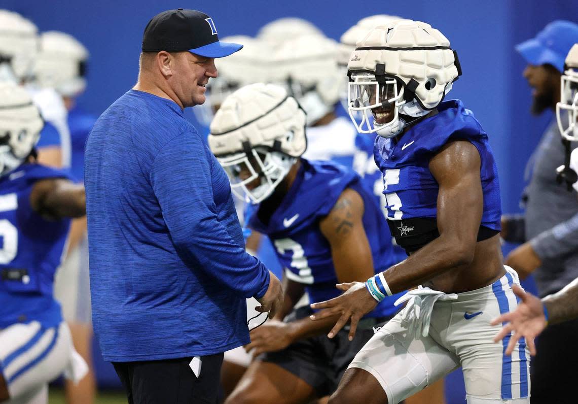 Duke head coach Mike Elko talks with wide receiver Jalon Calhoun (5) during the Blue Devils first practice of fall camp in Durham. N.C. Tuesday, August 2, 2022.