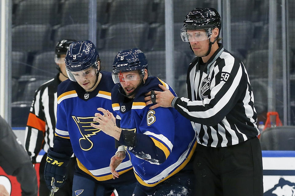 St. Louis Blues' Marco Scandella (6) is assisted by Sammy Blais (9) and linesman Ryan Gibbons (58) after being injured during the third period of the team's NHL hockey game against the Los Angeles Kings on Wednesday, Feb. 24, 2021, in St. Louis. (AP Photo/Scott Kane)