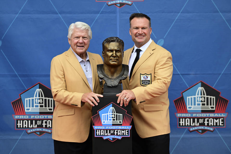 Former NFL player Zach Thomas, right, poses with his former coach Jimmy Johnson and his bust during his induction into the Pro Football Hall of Fame Class in Canton, Ohio, Saturday, Aug. 5, 2023. (AP Photo/David Dermer)