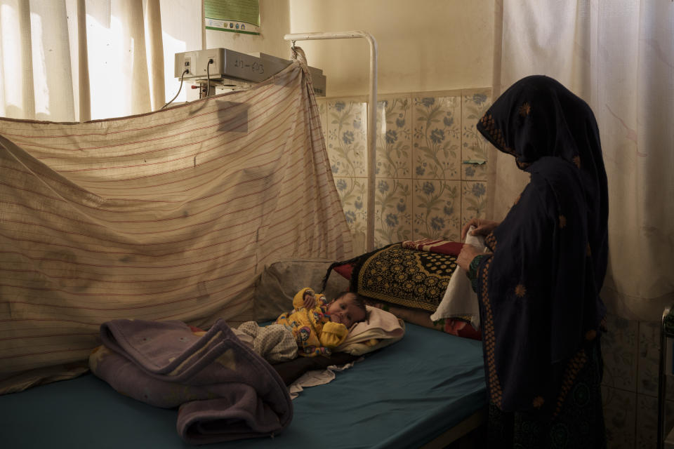 A woman changes the clothes of her baby in the malnourished ward of the Mohammed Khan Hospital in Sayedabad district, Wardak province, Afghanistan, Monday, Oct. 11, 2021. In urban centers, public discontent toward the Taliban is focused on threats to personal freedoms, including the rights of women. In Salar, these barely resonate. The ideological gap between the Taliban leadership and the rural conservative community is not wide. Many villagers supported the insurgency and celebrated the Aug. 15 fall of Kabul which consolidated Taliban control across the country. (AP Photo/Felipe Dana)