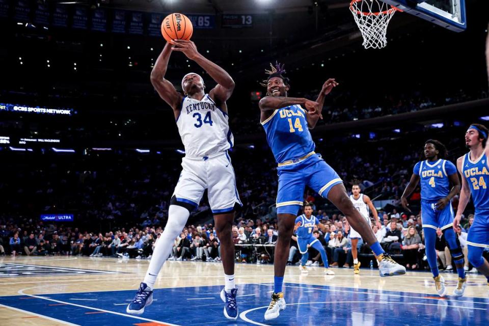 Kentucky forward Oscar Tshiebwe (34) grabs the ball away from UCLA forward Kenneth Nwuba (14) during the first half in the CBS Sports Classic on Saturday in New York.