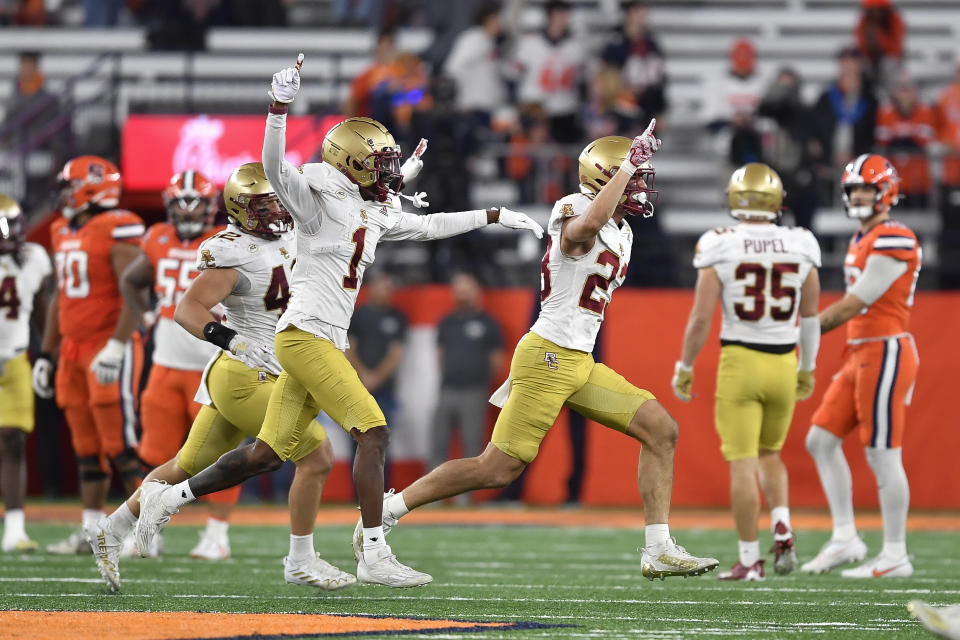 Boston College defensive back Cole Batson, right, celebrates with cornerback Elijah Jones (1) and linebacker Vinny DePalma (42) after his interception of a Syracuse pass during the second half of an NCAA college football game in Syracuse, N.Y., Friday, Nov. 3, 2023. (AP Photo/Adrian Kraus)