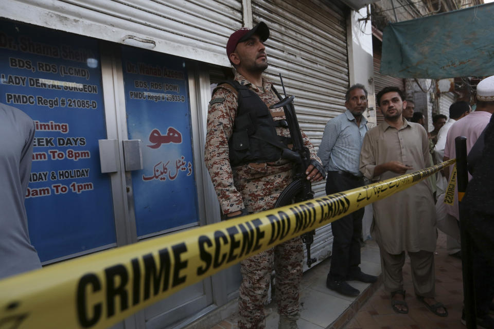 A paramilitary soldier stands guard outside a dental clinic after a firing incident, in Karachi, Pakistan, Wednesday, Sept. 28, 2022. A gunman shot and killed a dual national Chinese-Pakistani man in an attack at a dental clinic in the southern port city of Karachi on Wednesday before fleeing the scene, police said. (AP Photo/Fareed Khan)