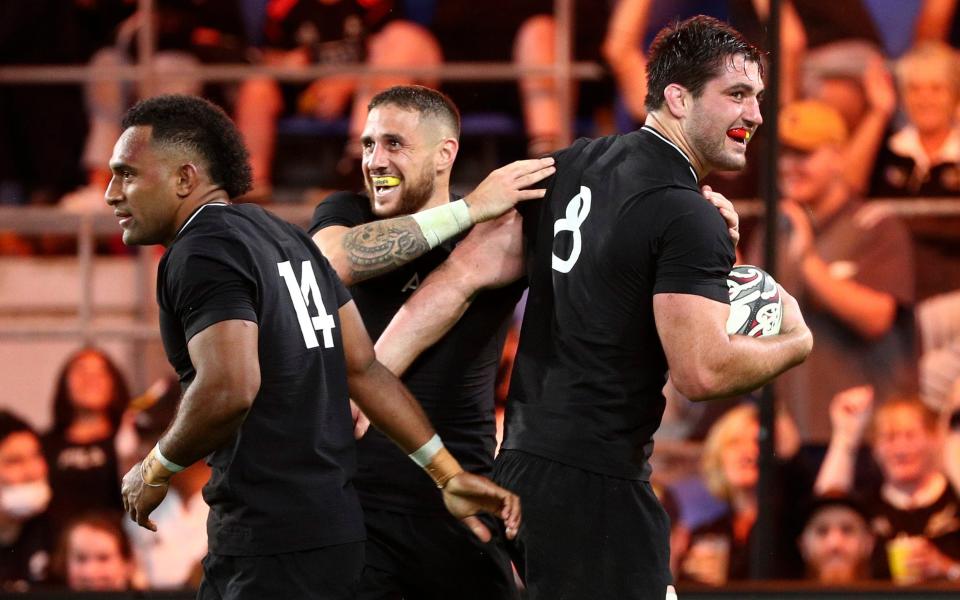 New Zealand's Luke Jacobson, right, is congratulated by teammates TJ Perenara and Sevu Reece after scoring a try against Argentina during their Rugby Championship match on Sunday, Sept. 12, 2021, on the Gold Coast, Australia - AP