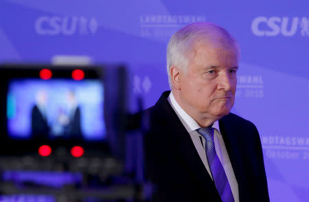 Leader of the Christian Social Union (CSU) Horst Seehofer arrives to give a speech after first exit polls in the Bavarian state election in Munich, Germany, October 14, 2018. REUTERS/Michaela Rehle