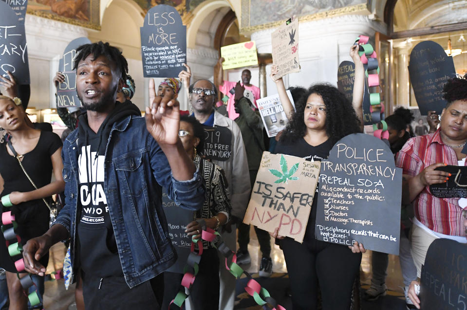 Jawnanza James Williams of VOCAL NY, left, speaks with a coalition of protesters urging legislators to pass legalization of marijuana legislation at the state Capitol Wednesday, June 19, 2019, in Albany, N.Y. A push to legalize recreational marijuana in New York state has failed after state leaders did not reach a consensus on several key details in the final days of the legislative session. (AP Photo/Hans Pennink)