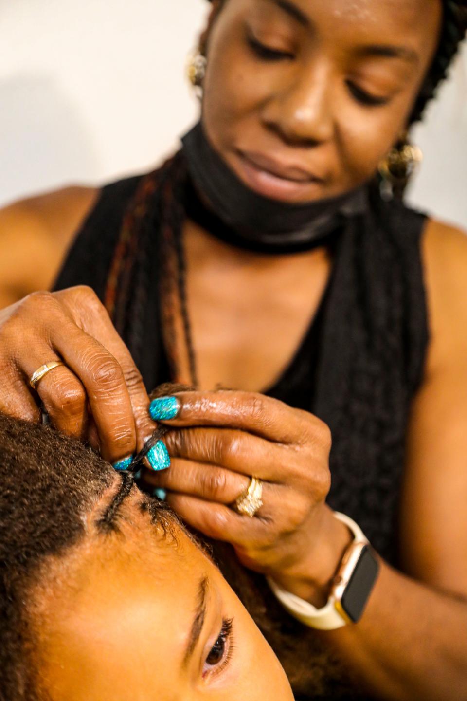 Stylist Charrell Brown works on kids braids on Wednesday, July 6 2022. She braided in cornrows and box braids. Brown is a stylist at Monique Smith's shop Beauty, Braids and Beyond in Fort Myers, Florida.
