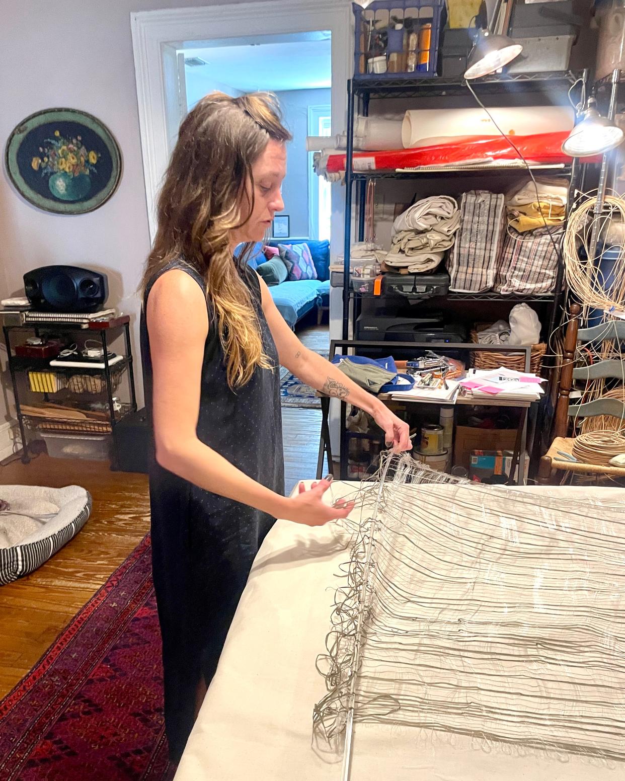 Fibers artist Katie Glusica working in her at-home studio.