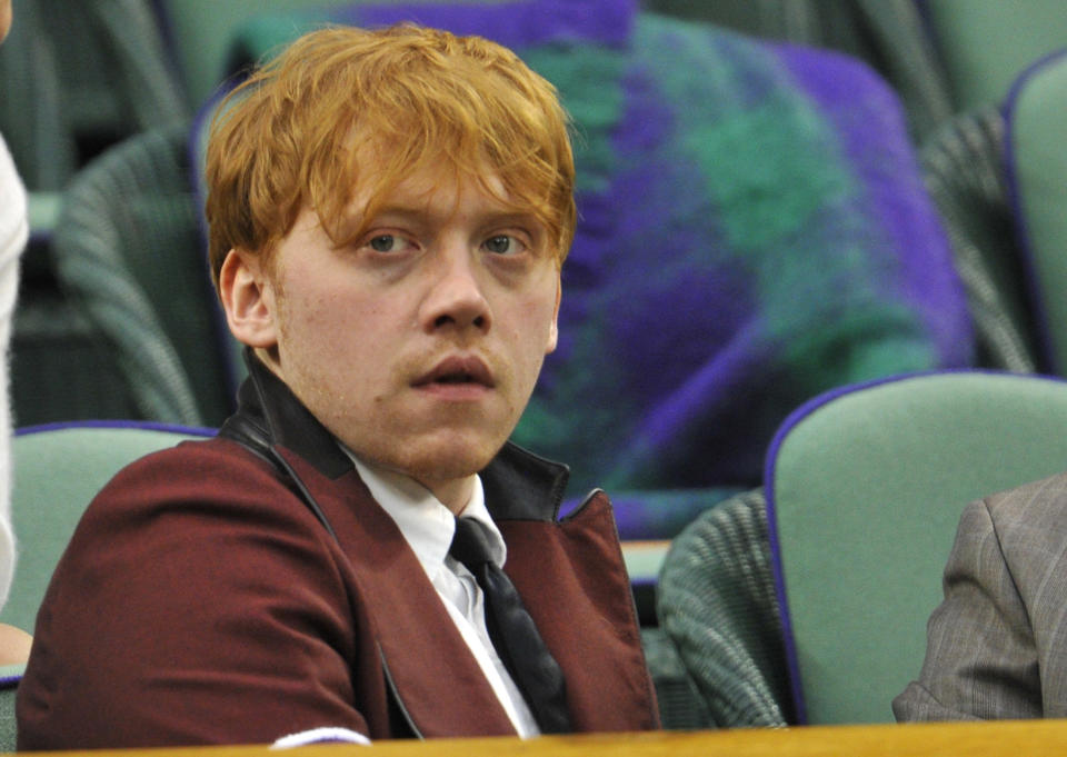 Actor Rupert Grint sits on Centre Court for the match between Andy Murray of Britain and Ivan Ljubicic of Croatia at the Wimbledon tennis championships in London June 24, 2011.                             REUTERS/Toby Melville (BRITAIN  - Tags: ENTERTAINMENT SOCIETY SPORT TENNIS)  